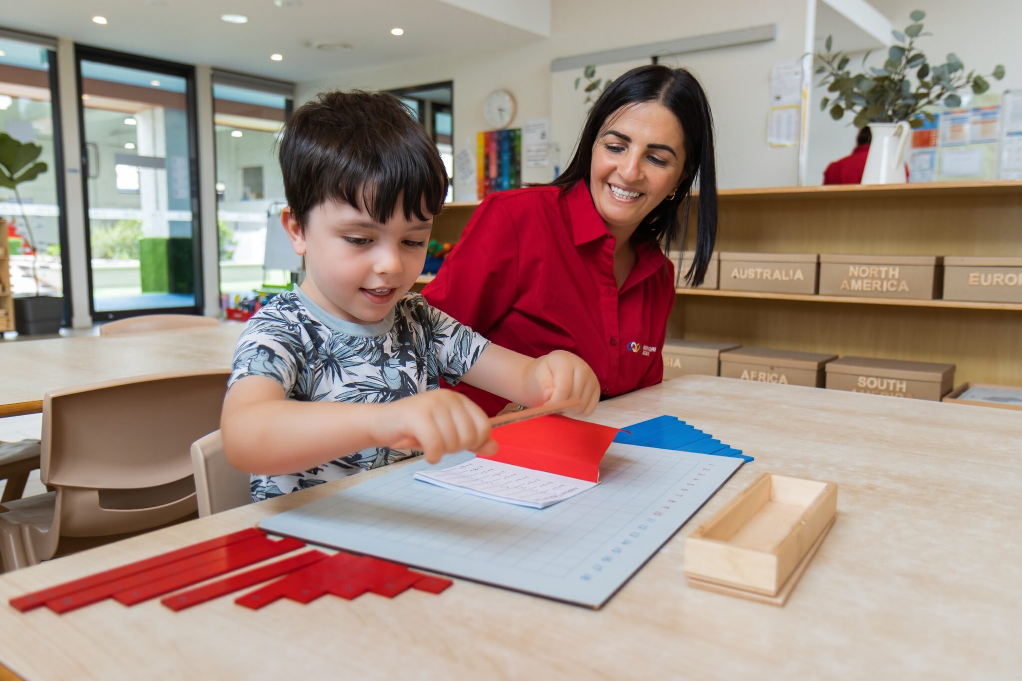 Child engaged in independent Montessori work cycle activity in a prepared classroom