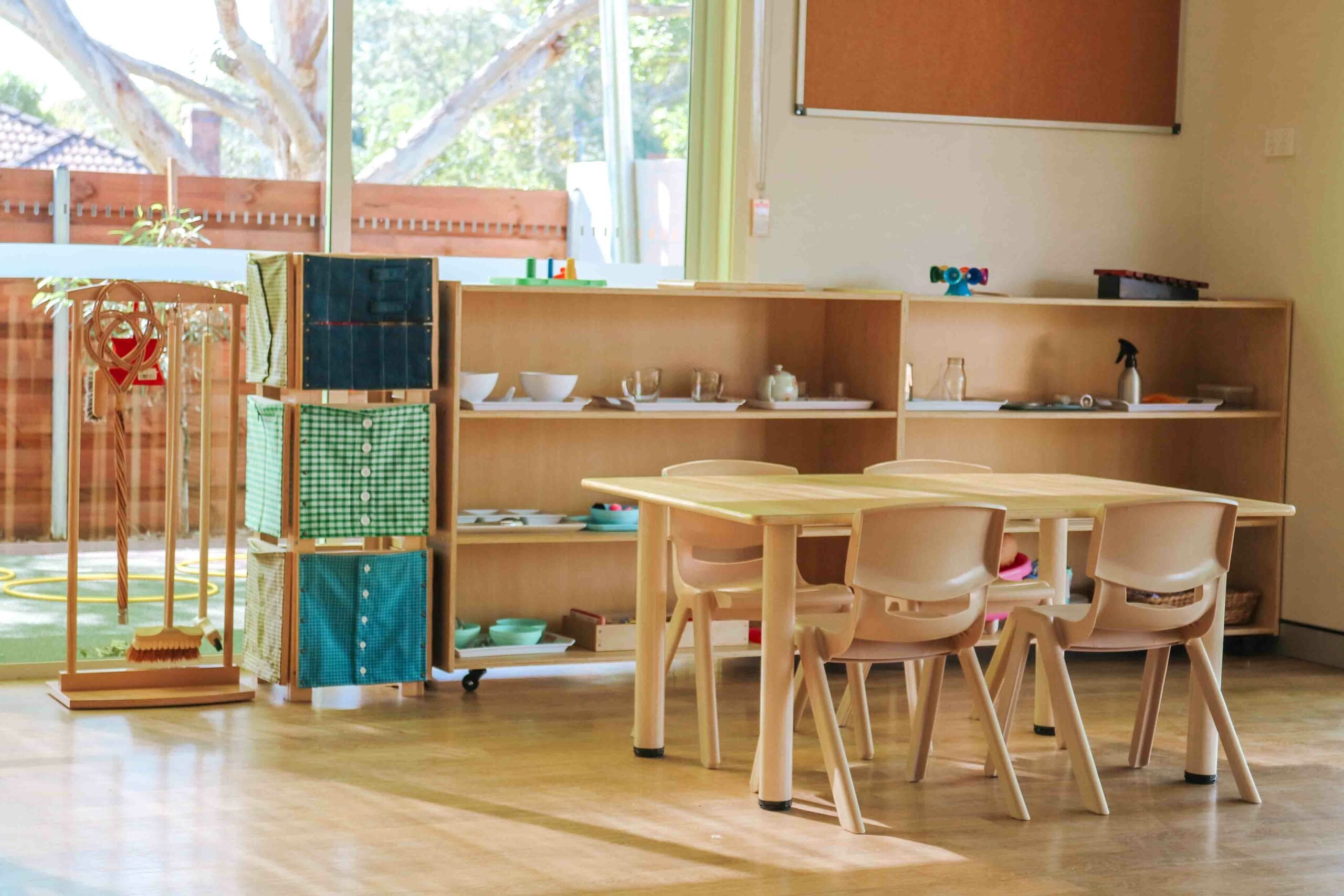 Classroom interior of Montessori Academy’s Turramurra daycare, with shelves of learning materials and a children’s table.
