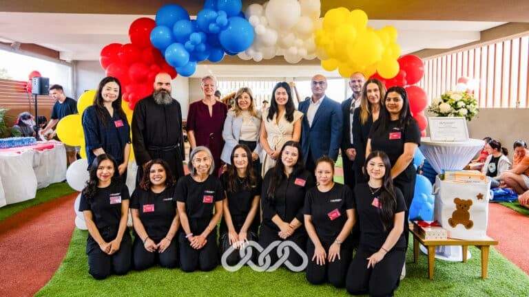 Montessori Academy Leadership and Centre team gather under colourful balloon arch with local community leaders at Campsie grand opening