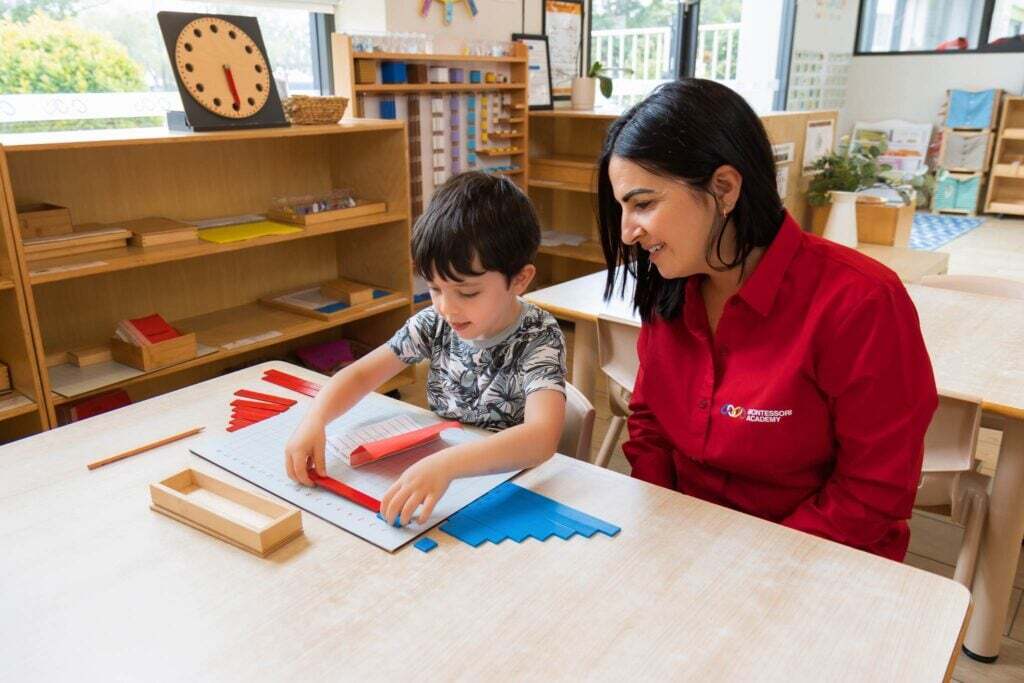 Montessori Preschooler engaging in maths activity with Montessori educator in Montessori preschool program