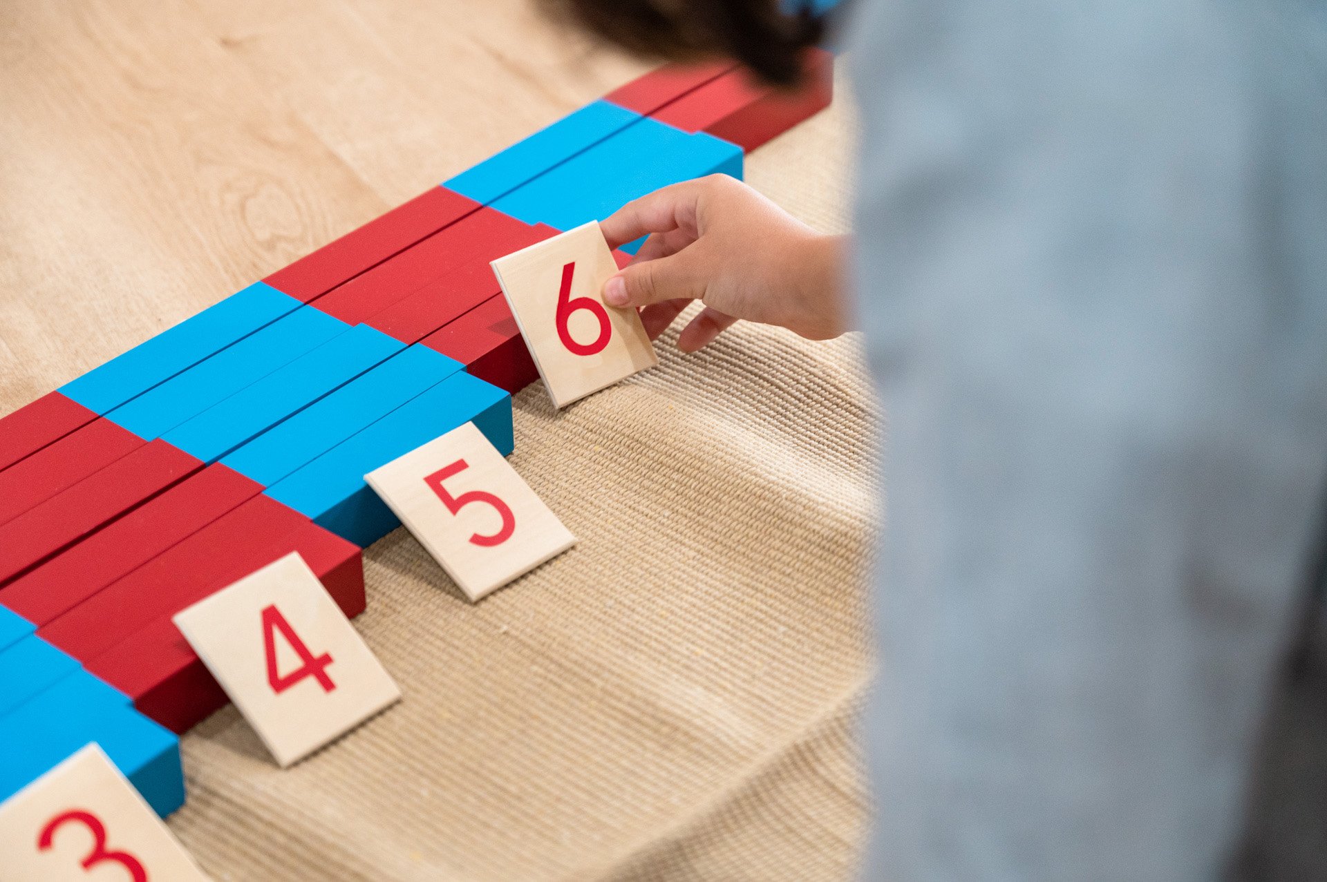  Recognises numerals and counts by rote